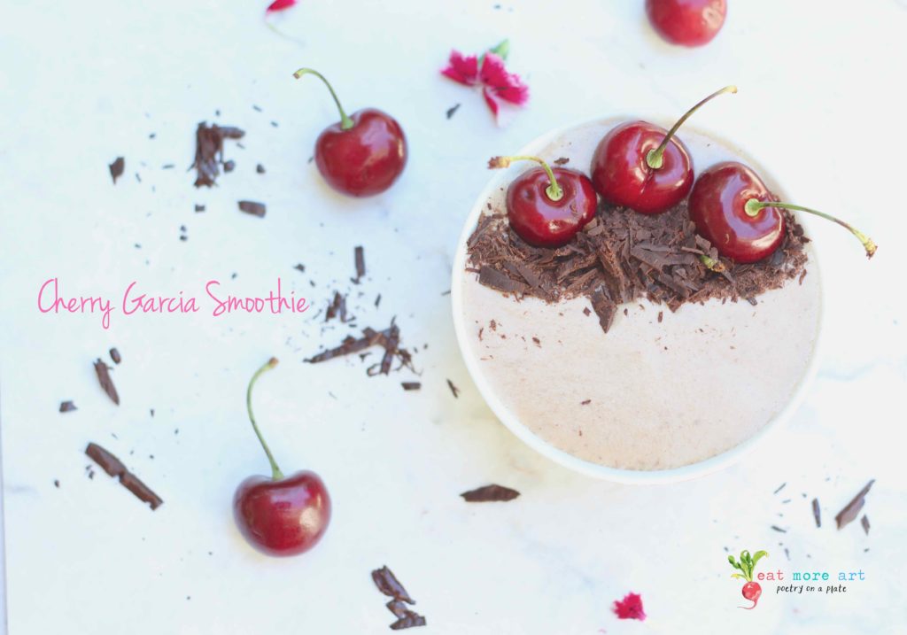 An overhead shot of cherry garcia smoothie bowl garnished with dark chocolate and cherries