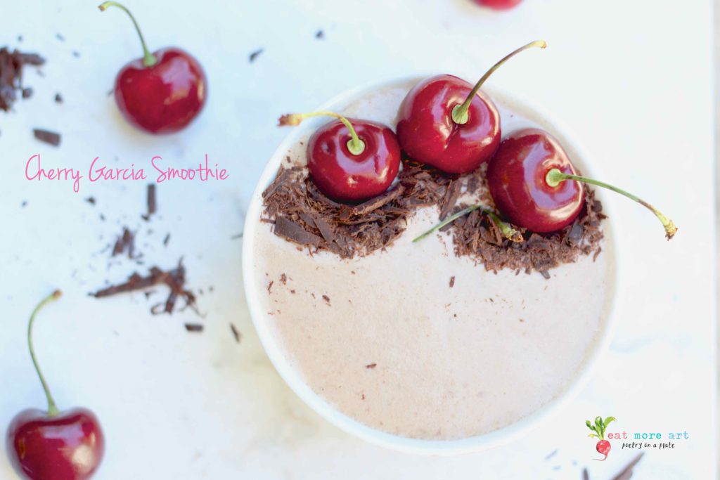 An overhead shot of cherry garcia smoothie bowl garnished with dark chocolate and cherries