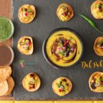 An overhead shot of Dal Pakwan bites served with chutneys