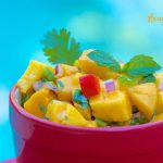 A close up shot of a bowl of mango salsa